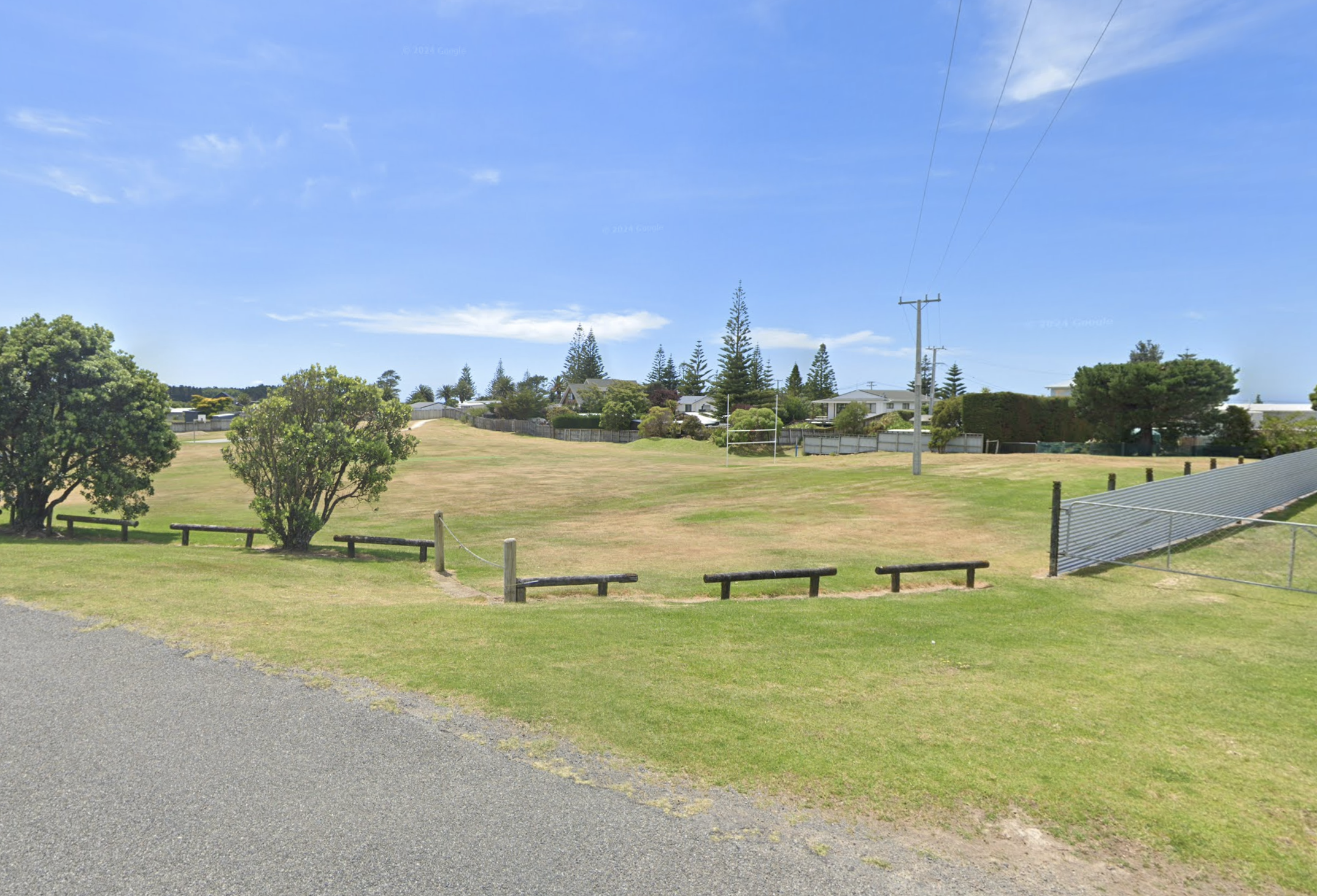 Open grassy field with rugby goal posts 
